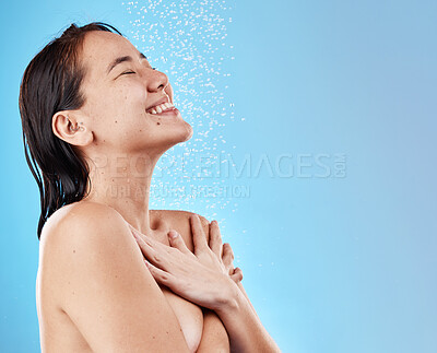 Buy stock photo Woman, happy and shower, water and cleaning body for hygiene against blue studio mockup background. Asian female, model and shortless while showering, happiness and clean with smile and bathroom