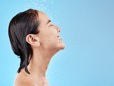 Buy stock photo Asian woman, shower and water for cleaning, smile and happy in blue studio mockup background. Model, clean and showering face, body and hygiene, skincare or cosmetic beauty in bathroom with happiness