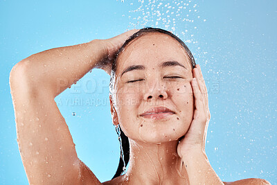 Buy stock photo Beauty, skincare and hair, woman in shower on blue background, haircare and hygiene routine in the morning. Model in water splash, cleaning hair and face with running water for clean fresh lifestyle.