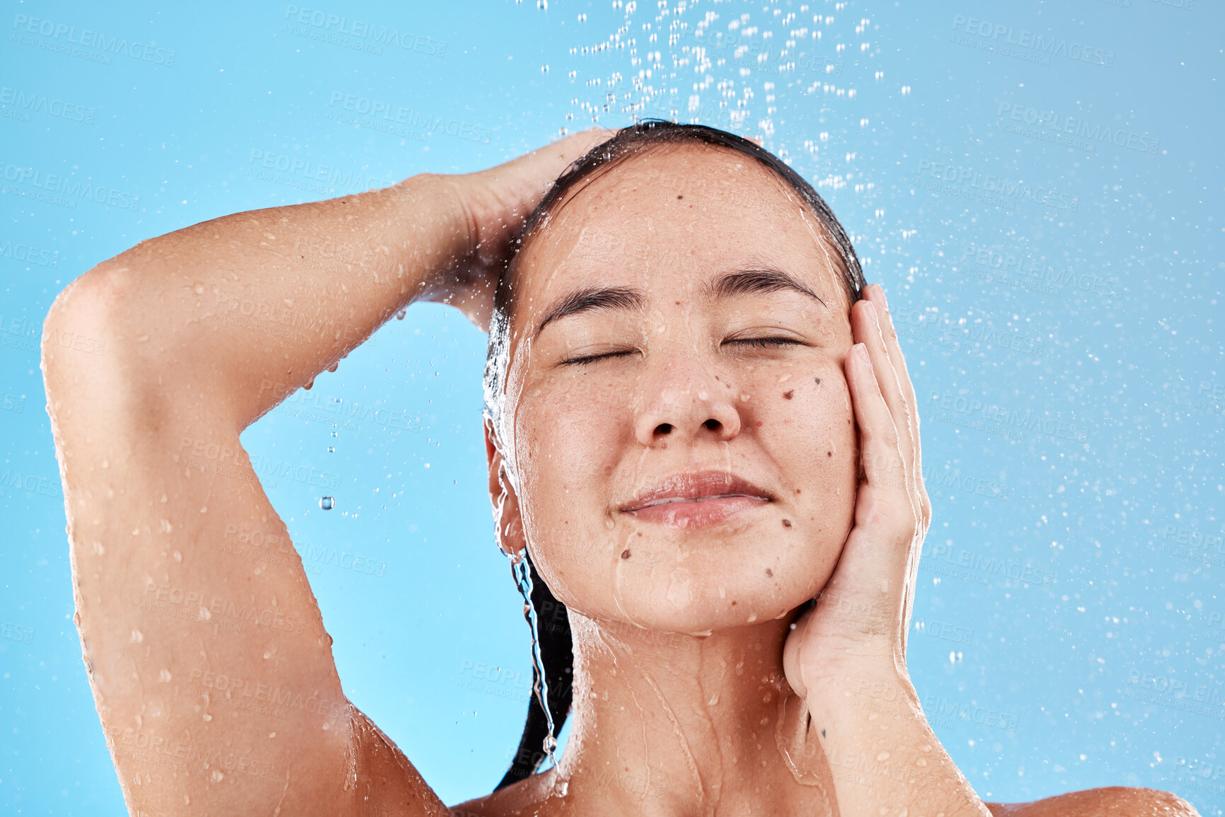 Buy stock photo Beauty, skincare and hair, woman in shower on blue background, haircare and hygiene routine in the morning. Model in water splash, cleaning hair and face with running water for clean fresh lifestyle.