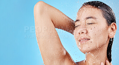 Buy stock photo Woman, face and shower for skincare hydration, hygiene or beauty against a blue studio background. Female smile in relax for fresh clean water wash in body care or healthy moisture for skin on mockup