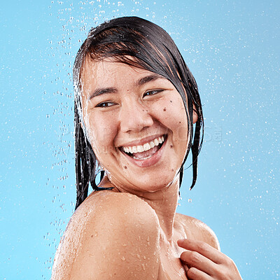 Buy stock photo Shower, water drops and skincare woman in studio for beauty, cosmetics cleaning and facial wellness on blue background. Happy, asian or Japanese model washing face and hair care with water splash