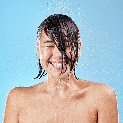 Buy stock photo Water, shower and woman skincare, cleaning and wellness against mockup studio blue background with smile. Happy, asian female and model wet, clean and beauty care, face and body wash for skin health