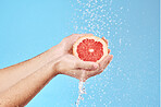 Grapefruit in hands, water splash and studio background for healthy, vegan and wellness food on advertising, marketing or promotion mockup. Detox, vitamin c and juice fruit benefits in clean skincare