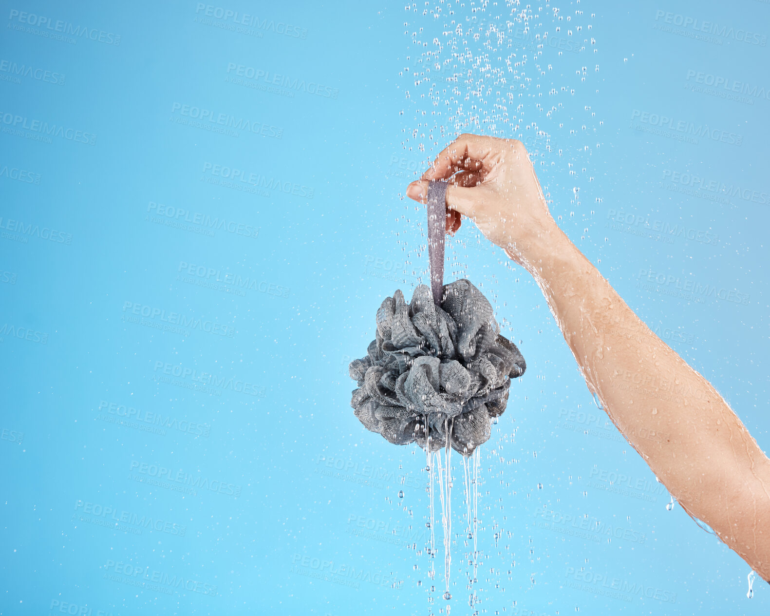 Buy stock photo Shower, water and hands of woman with loofah for daily bathroom routine, body cleaning and self care. Skincare mockup, hygiene and wet girl washing with body care product isolated on blue background