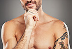 Thinking model, body and arm tattoos on gray studio background with shirtless chest, strong muscles or bodybuilding progress. Zoom, fitness man and boydbuilder person trainer with training goals idea