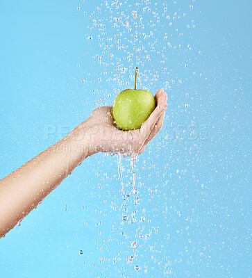 Buy stock photo Apple, hand and health nutrition with water cleaning fruit with wellness, diet or fruit model for advertising. Detox, natural and healthy lifestyle person with blue studio marketing and splash mockup