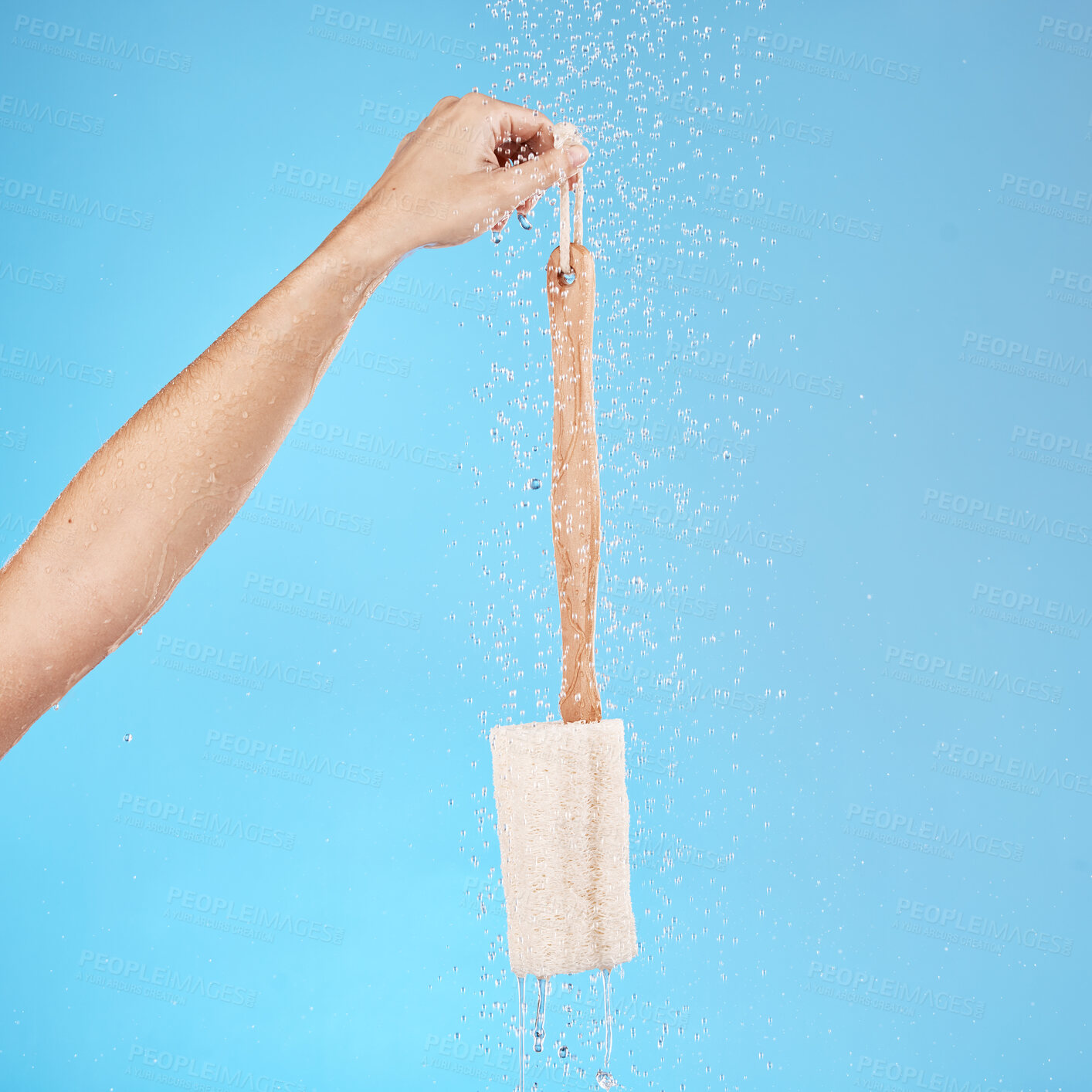 Buy stock photo Shower, back brush and body loofah of cleaning, skincare massage or hygiene on studio blue background. Woman hands, water splash and bath sponge, wellness and eco bamboo beauty product for clean skin