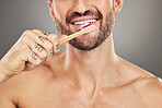 Man, mouth and toothbrush for dental care, hygiene and health on with a brush on a grey studio background. Oral care, healthy teeth and dental wellbeing or cleansing or clean grooming routine 