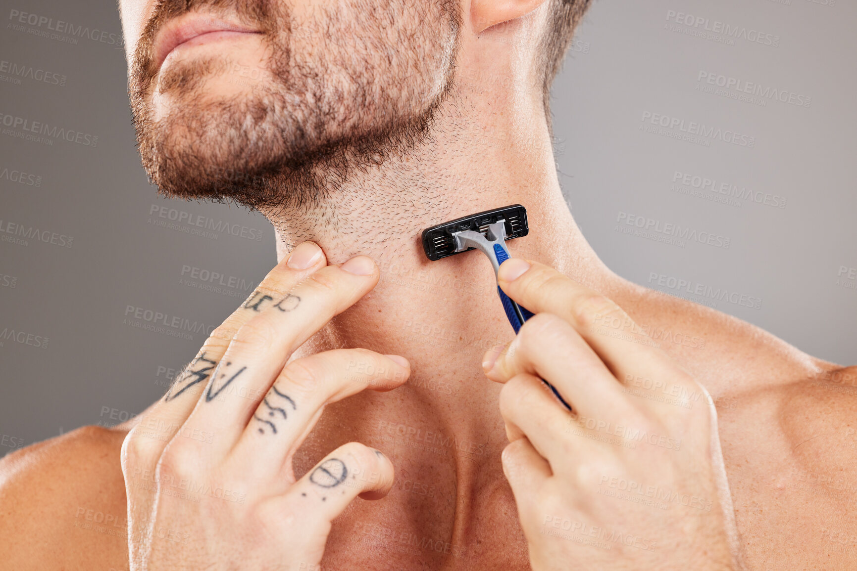 Buy stock photo Grooming, beard and man shaving hair for skincare, wellness and health against a grey studio background. Dermatology, hygiene and hands of a model with a razor to shave neck for a fresh treatment