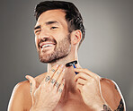 Beard, smile and man shaving face for clean, healthy and beauty skin against grey studio background. Wellness, skincare and happy young cosmetic model with a razor to shave facial hair for grooming