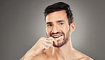 Man, brushing teeth and dental healthcare for beauty smile or grooming morning routine with toothbrush in studio. Face, smile and hygiene health with model cleaning teeth portrait in grey background 