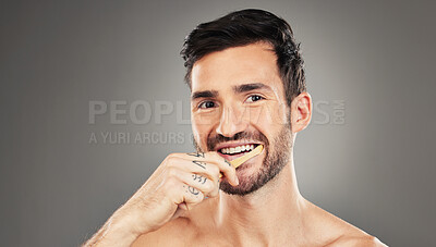 Buy stock photo Man, brushing teeth and dental healthcare for beauty smile or grooming morning routine with toothbrush in studio. Face, smile and hygiene health with model cleaning teeth portrait in grey background 