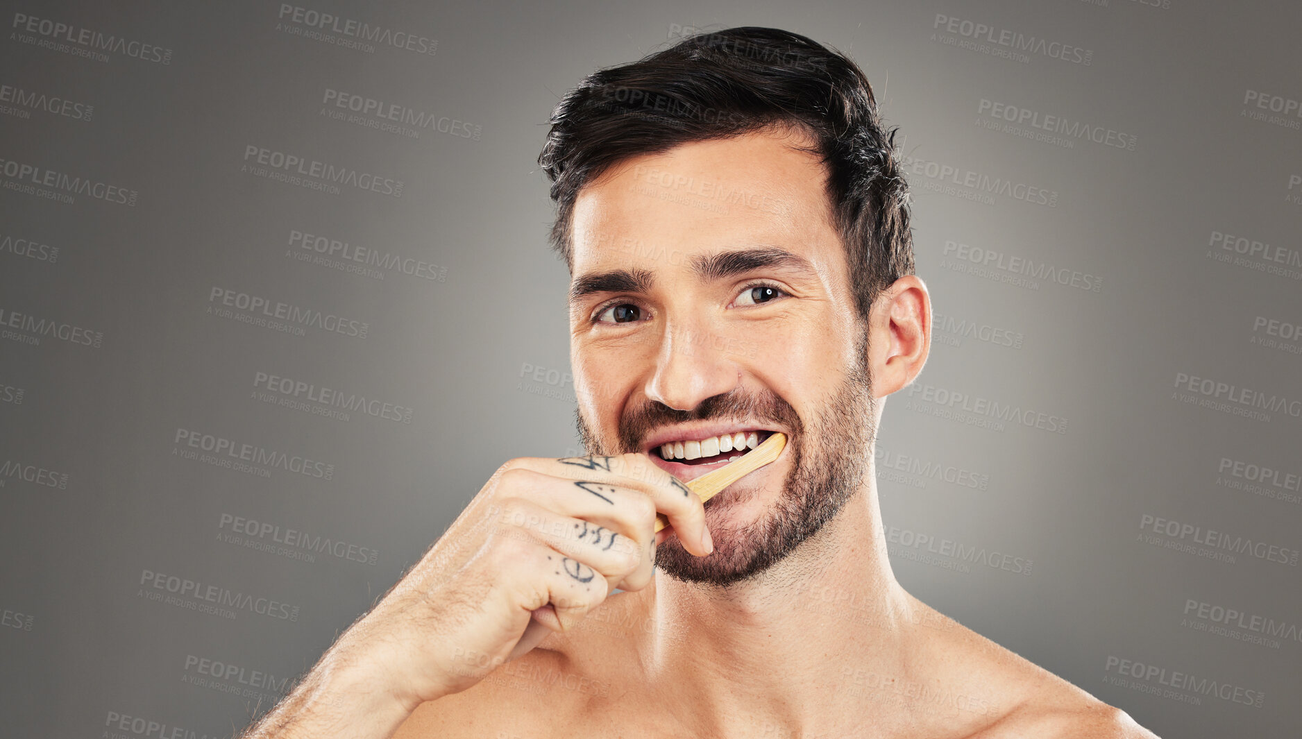 Buy stock photo Man, brushing teeth and dental healthcare for beauty smile or grooming morning routine with toothbrush in studio. Face, smile and hygiene health with model cleaning teeth portrait in grey background 