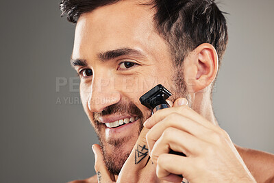 Buy stock photo Face, skincare and man shaving with razor in studio isolated on gray background mockup. Smile, wellness and happy male model from Australia shave beard or facial hair for grooming, beauty or hygiene