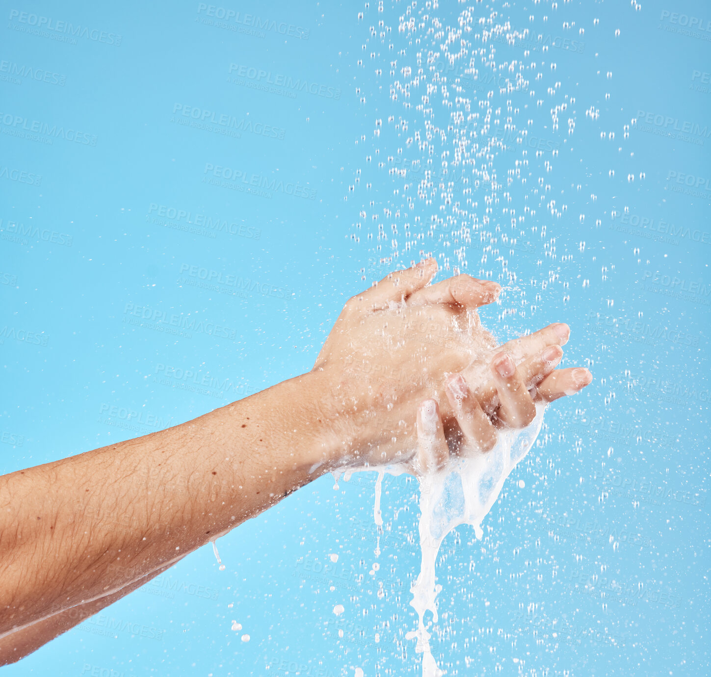 Buy stock photo Cleaning hands, water splash and wash for hygiene, healthcare and wellness mockup on a blue studio background. Skin hydration, moisturizing skincare skin and protect from bacteria, germs and disease 