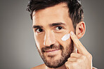 Portrait, skincare and man with face cream in studio for moisturizing on gray background mockup. Beauty, male and model from Canada apply cosmetics product, facial creme or lotion for healthy skin.