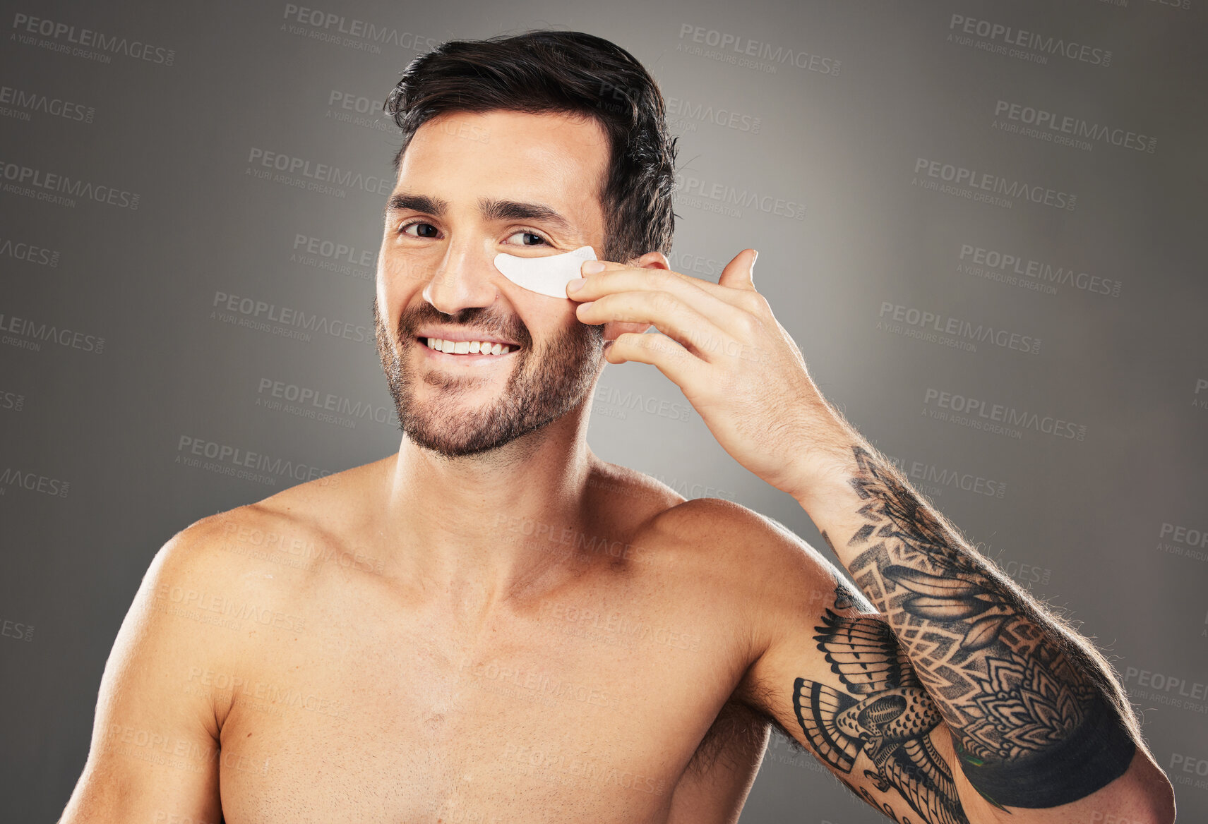 Buy stock photo Skincare, face and man with eye patch on a gray studio background. Portrait, beauty and male model from Australia with facial product, cosmetics pads or collagen eye mask for hydration or anti aging.