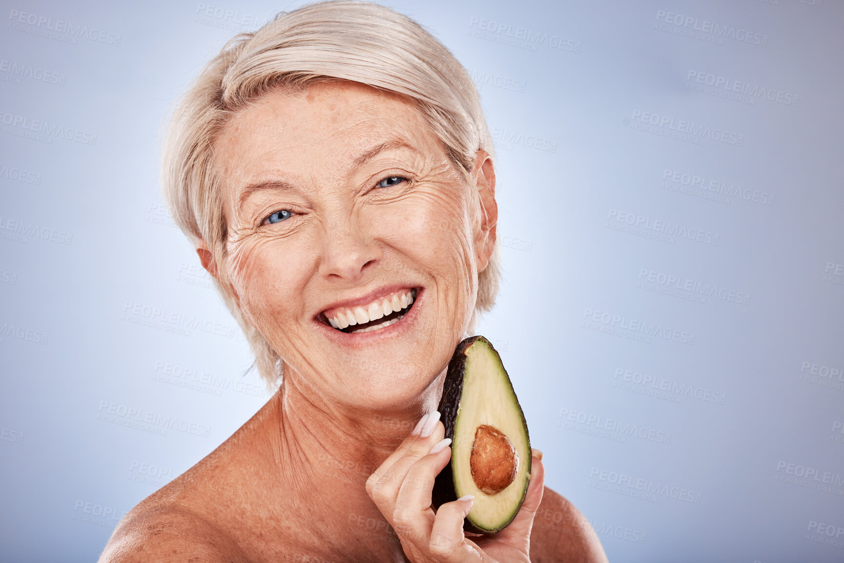 Buy stock photo Senior woman with avocado, natural skincare for plant based product with healthy ingredient. Portrait of happy elderly lady, smile with fruit for face mask and vegan cruelty free lifestyle in studio