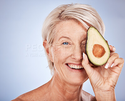 Buy stock photo Face, skincare and avocado with a senior woman in studio on a gray background to promote antiaging antioxidants. Portrait, cosmetics and natural treatment with a mature female posing for wellness