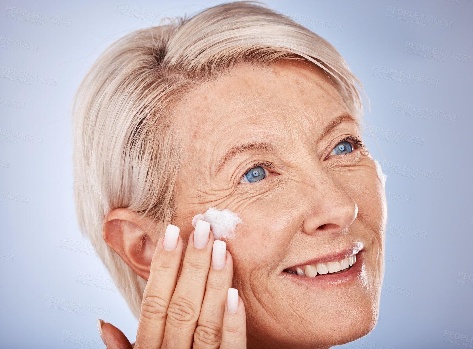 Buy stock photo Skincare, thinking and senior woman with cream for face against a grey studio background. Sunscreen, happy and elderly model with an idea with a facial dermatology product for beauty and self care