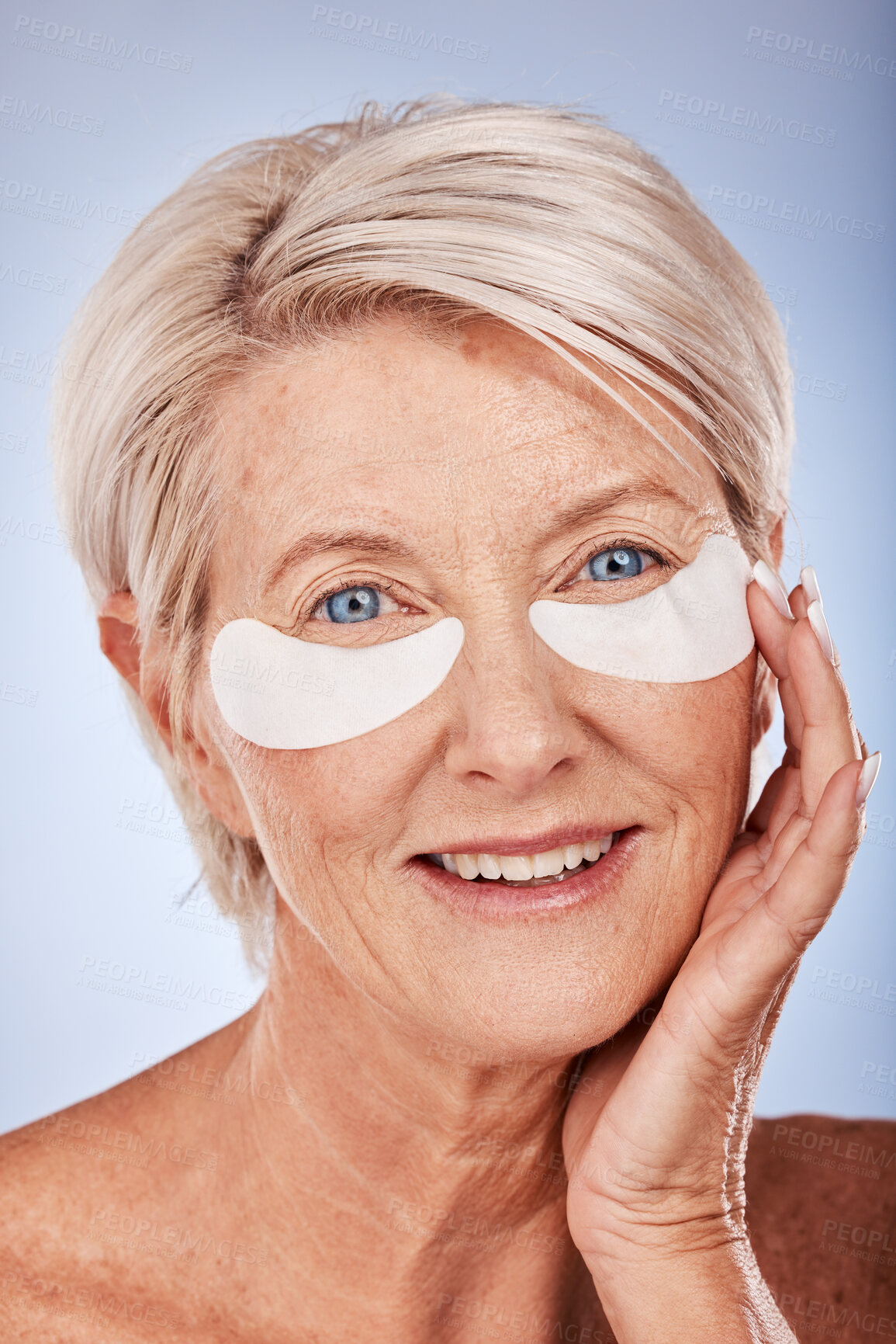 Buy stock photo Skincare, beauty and senior woman with patches for eyes, wellness and cosmetics against a grey studio background. Spa, luxury and elderly model with a facial product for body care, wrinkles and aging