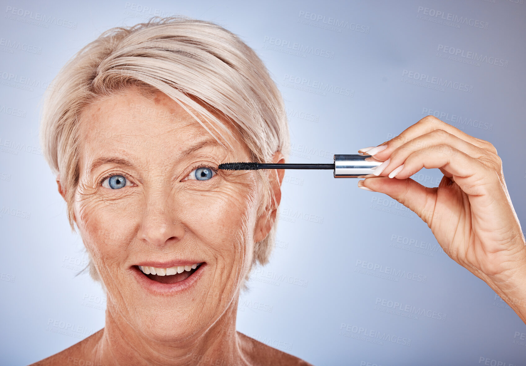 Buy stock photo Portrait of senior woman with mascara brush, cosmetic beauty product and makeup wand for eye lashes in Sydney. Surprised smile in studio with gray background, natural blue eyes and luxury skincare