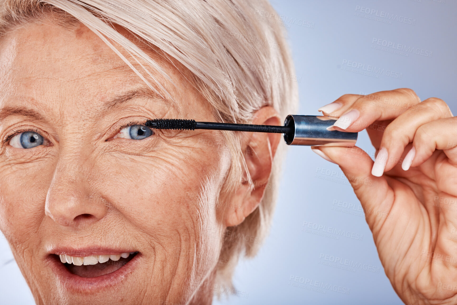 Buy stock photo Makeup, wow and senior woman with mascara for beauty, cosmetics and care for eyelash against a grey studio background. Happy, portrait and face of elderly cosmetic model with a product for a makeover