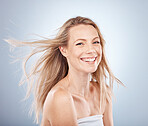Skincare, beauty and hair, portrait of woman with smile on face and natural salon hair style on blue background. Health, wellness and luxury hair care, healthy body care and beautiful studio model.
