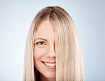 Hair care, smile and portrait of a woman with straight hair against a grey studio background. Wellness, luxury and face of a happy, blonde and beauty model with healthy, clean and beautiful long hair