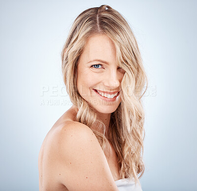 Buy stock photo Face, beauty and hair with a model woman in studio on a gray background to promote natural keratin treatment. Portrait, cosmetics or haircare with an attractive young female proud of her strong locks