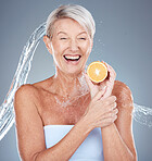 Woman, water splash and lemon for senior healthcare or skincare beauty. Elderly model, vitamin c nutrition and cosmetic wellness or natural body care, happy and relax shower in grey background studio