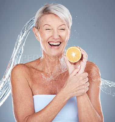 Buy stock photo Woman, water splash and lemon for senior healthcare or skincare beauty. Elderly model, vitamin c nutrition and cosmetic wellness or natural body care, happy and relax shower in grey background studio