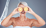 Water splash, fruit and senior skincare of a woman holding orange for vitamin c and skin glow. Beauty, clean detox and cosmetic health wellness of a model happy about shower, diet and nutrition