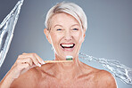 Senior woman, brushing teeth with toothbrush and water splash to clean dental hygiene, oral healthcare and mouth wellness. Portrait of happy smile, toothbrush and toothpaste for tooth cleaning mockup