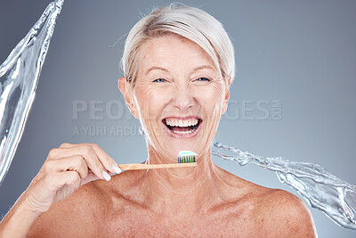 Buy stock photo Senior woman, brushing teeth and water splash on bamboo toothbrush for clean dental hygiene, wood healthcare product and mouth wellness. Happy smile, eco friendly toothpaste and tooth cleaning mockup