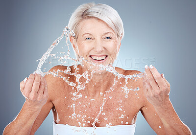 Buy stock photo Water splash, mature woman cleaning face on gradient background for health, beauty and skin care routine. Skincare, cosmetics and portrait of happy senior woman with smile washing in water in studio.