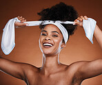 Face, beauty and hair with a model black woman in studio on a brown background for natural haircare. 