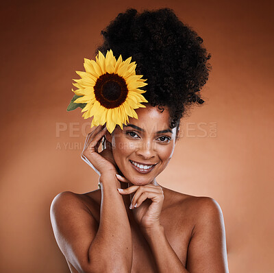 Buy stock photo Beauty, skincare and black woman with flower in hair, portrait of happy lady with salon afro hairstyle, and smile on face. Nature, natural organic skin and haircare product for woman with sunflower.