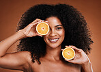 Black woman, orange and beauty healthcare or vitamin c nutrition for skincare health. Portrait of African girl model, fruit wellness or healthy cosmetics and spa therapy in brown background studio