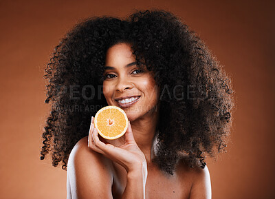 Buy stock photo Orange, health and face of a black woman with fruit for skincare, nutrition and marketing against a brown studio background. Advertising, vitamin c and African model with food for nutrition and detox