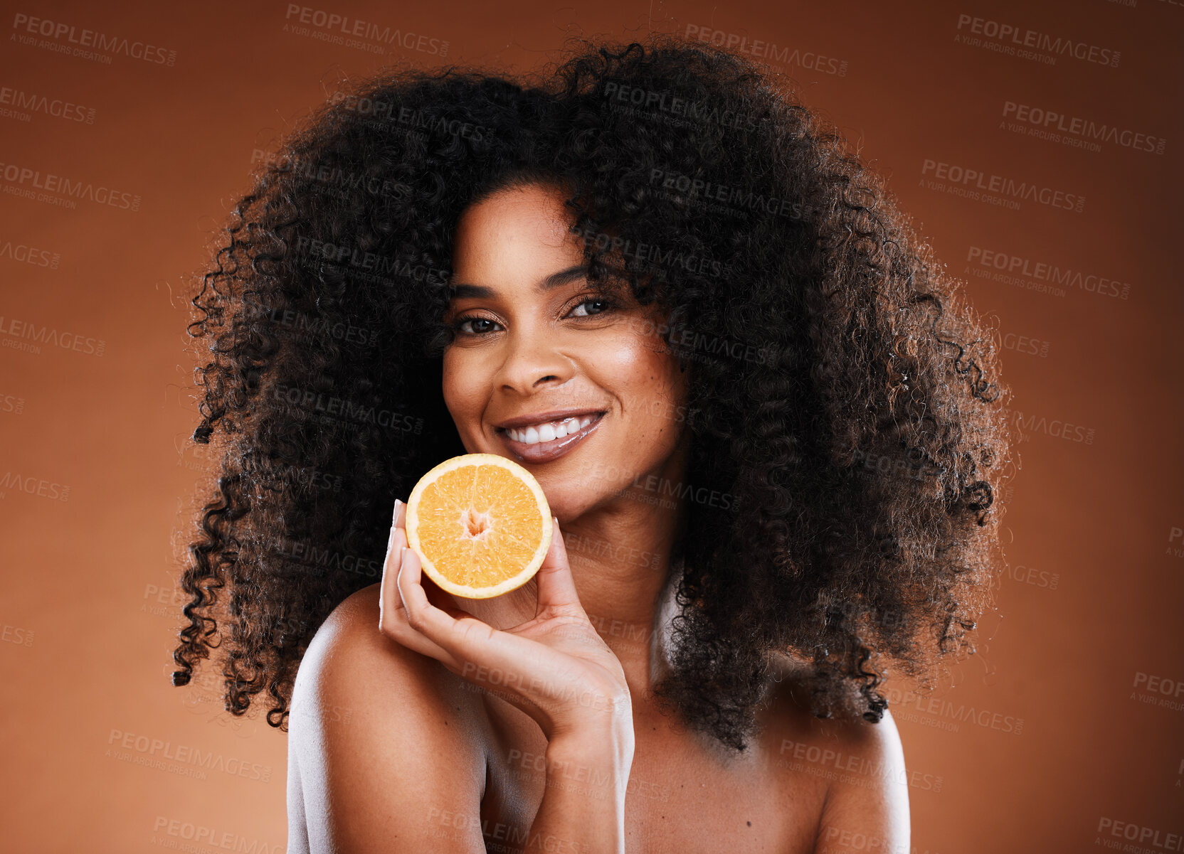 Buy stock photo Orange, health and face of a black woman with fruit for skincare, nutrition and marketing against a brown studio background. Advertising, vitamin c and African model with food for nutrition and detox