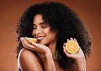 Lemon, natural beauty and black woman in studio for skincare, hair care and vitamin c cosmetics promotion, marketing or advertising. Happy model smell lime fruits for detox or skin care benefits