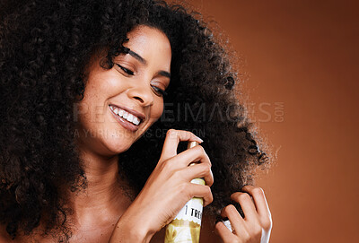 Buy stock photo Black woman, afro and cosmetics hair spray oil for haircare wellness or natural growth treatment. African girl, luxury spa product and healthy beauty glow or hair care in brown background studio