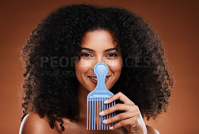 Buy stock photo Beauty, hair care and portrait of black woman with comb for afro, natural and curly hair on brown background. Hair salon, cosmetics and girl with hair brush in hand for combing or grooming in studio