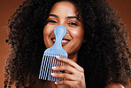 Black woman, curly hair comb and afro beauty, hairstyle and hair care on studio background. Portrait happy african girl model, hair brush or hair styling tool in fashion, cosmetics and natural trends