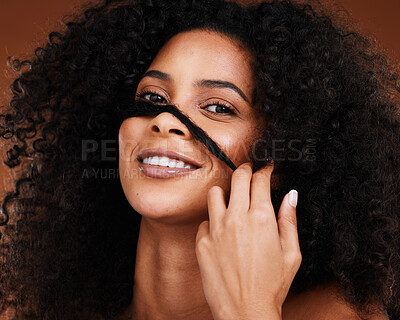 Buy stock photo Black woman afro, hand and smile for hair cosmetics, care or treatment against a studio background. Portrait of African American female model smiling with teeth in satisfaction for salon hairstyle