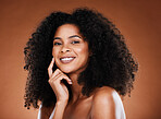 Hair care, beauty and portrait of black woman with afro on brown background in studio for wellness. Beauty, cosmetics and happy female model with glowing skin, healthy and natural curly hairstyle