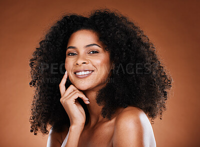 Buy stock photo Hair care, beauty and portrait of black woman with afro on brown background in studio for wellness. Beauty, cosmetics and happy female model with glowing skin, healthy and natural curly hairstyle