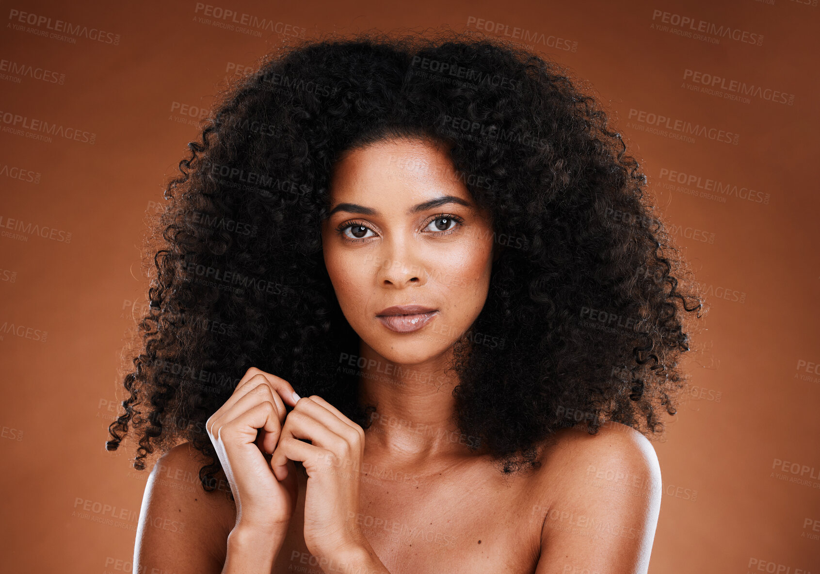 Buy stock photo Black woman afro, beauty and makeup in skincare cosmetics against a studio background. Portrait of curious African American female model with curly hairstyle for salon or cosmetic hair treatment